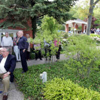          Jim Schmiechen speaks at the opening party, Harold Thieda on PA.
   