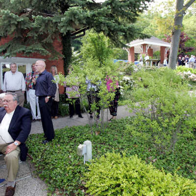 Jim Schmiechen speaks at the opening party, Harold Thieda on PA.