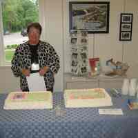          IMG_9859.JPG 999KB; Peg Sanford ready to serve cakes decorated with the messages 