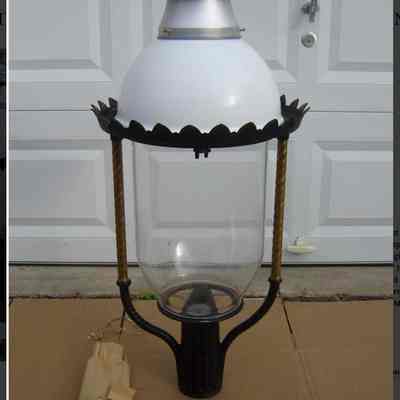 How the lamp looked when it was new.: https://www.worthpoint.com/worthopedia/huge-welsbach-36-boulevard-gas-light-1787058808
"One Original Welsbach No. 36 Boulevard Gas Street Light Head Patented Oct 31 1899 No. 31745." Height is 41 1/2" high x 18" wide. Made out of Cast Aluminum, Large Glass Globe, Milk Glass Dome, Aluminum Top and comes with all gas unit parts for the head. Base of the light slip over a 3" pole."