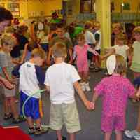          Nyla Hensley, wearing green t-shirt on the far left, leads the children in an activity
   