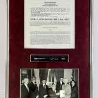          L. Enrolled House bill No. 4827 with photo and pen. 1997; Photo of Birkholz with Michigan Governor John Engler. 26x14x2