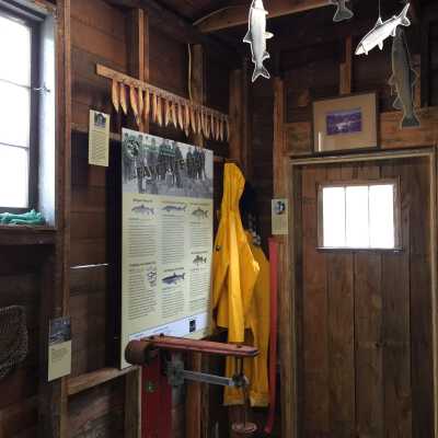Photo of the Bonnie (over door), yellow rain slicker and bibs, chub smoking stick and scale