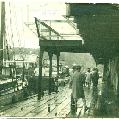 Pavilion dock by Simmons ca 1952: People and sailboats at the Pavilion Dock