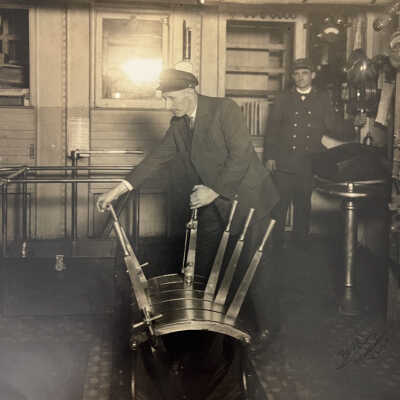 Thomas Richard Martin at wheel of ship