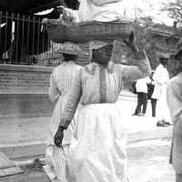          Woman with basket of goods balanced on her head
   