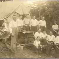          021.HardCoreCampersSaug.jpg 129KB; Eleven man and boys pose with their tent that is furnished with an iron stove.
   