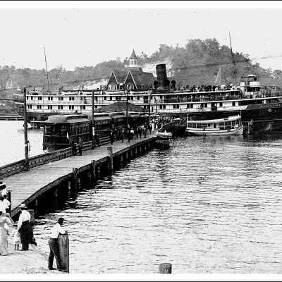 Passengers debark from “Puritan” on Lake Macatawa to board Interurban for Saugatuck. ca 1912: Interurban at Macatawa ca 1900