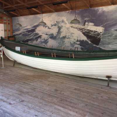 "Chicora lost at sea" by Randall Higdon: The original 22"x48" painting enlarged into a 47ft x 9.5ft mural is a suitable backdrop for the lifeboat.

Randall Higdon is a well recognized Michigan artist with a studio in Coloma, MI. The original painting was commissioned by the Society in 2002 and is now in the possession of Andrew Plummer of Douglas. The enlarged digitized image incorporates the names of 100 people lost in Great Lakes shipwrecks.