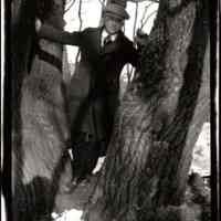          95-52-1a_man unknown.jpg 240KB; Man in a long coat standing in a gap between two trees.
   