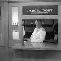          Ev Bekken at the window, at post office when it was at 238 Butler Street.
   