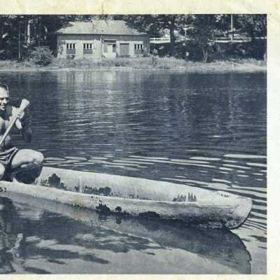 Morgan J. Edgcomb Jr. paddling the canoe from article from Commercial Record: INDIAN Joe Shashaguay was the best doggone dugout maker in southwest Michigan.
Any red man of the middle 1800's would have told you that. And since this 110-year-old example is still afloat, no one around will argue the point.
Joe made it for Lou Hamlin, a Saugatuck pioneer of the 1840's, and Lou sold it to Morgan Edgecomb for $3, better than 50 years ago. Edgecomb used it awhile for duck hunting and then shoved it under the porch where it lay for 30 years.
Recently his son, Jay (left), dug it out and put it back in use.
[Morgan Edgcomb Sr. purchased the canoe, and his son Morgan J. Edgcomb Jr. is shown paddling the craft]