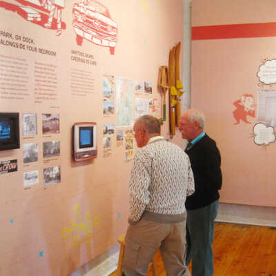 Ted Reyda and Forrest Morris view the commercial: Commercial features shots of favorite tourist spots circa 1954