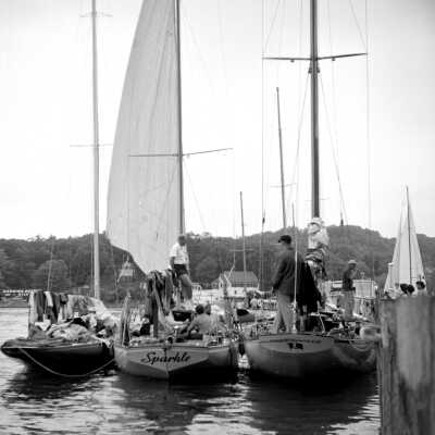 565 19/18	Saugatuck - yachts	1955	Yachts docking at Big Pavilion: One of the boats is named Sparkle.
This image was featured as History Mystery #33 with the solution: The race was the Chicago to Saugatuck sailboat race and the photo can be dated by the Harding Hotel sign in the lower left corner. 
The Harding Hotel operated c1947-1954