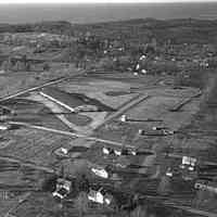          Here’s an aerial photo taken in the 1950s.
There are several clues which might help us date it.
   