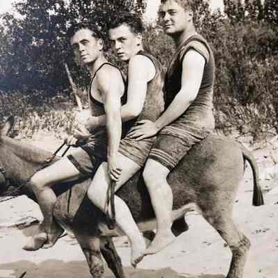 Tieler Niedzwiecki Dynamite postcard 1909: Three men in swimsuits aboard Dynamite