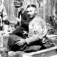          Herman Hirner enjoys picnic lunch, Osa Welch in Background
   