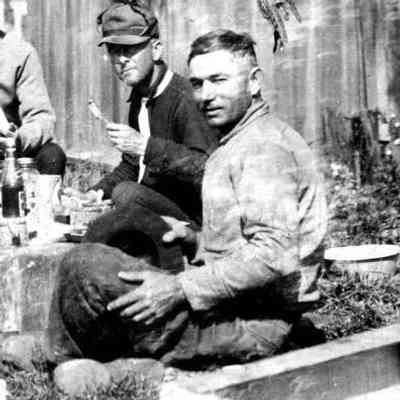 Herman Hirner enjoys picnic lunch, Osa Welch in Background