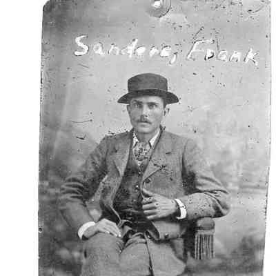 89-1-206_Frank_Sanders.jpg 418KB: Frank Sanders wearing hat seated in chair for studio portrait