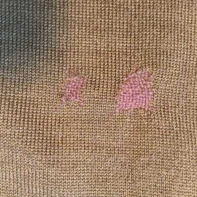 An expert darning job on elbow.