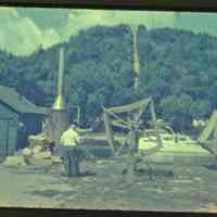          SewersFishhouse.jpg 1.4MB; Sewers fishing operation on Water Street with green shanty, fish boxes, boiler for steaming/disinfecting nets, two men winding cleaned nets on reels. Mt. Baldhead in the background.
   