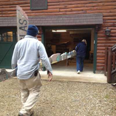 Dec. 8. 2011 totem restoration: Marilyn Starring and unidentified man carry the totem into Arnold Schafer's garage