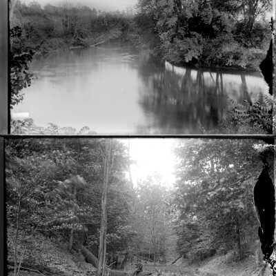 Tannery_creek-Born_Island.jpg 1.7MB: smooth surface of a river, man sitting on log over creek
