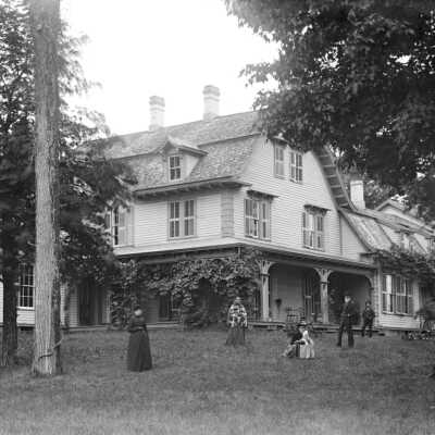 Big_house.jpg 1MB: family posed in front of large home