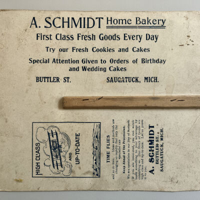 Reverse side of A. Schmidt Home Bakery hand fan.: The handle is broken.