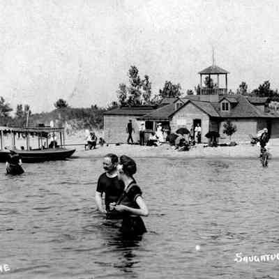 BeachHouse.s snaps.jpg 293KB - Digital file on Jack Sheridan Drive 2021.72.02: Visitors wade in the water in this Bathing Scene at the Bird Beach house. A motor launch brought visitors to the beach just south of the old channel mouth [today's Saugatuck Harbor Natural Area] from Saugatuck. The beach house rented swimming attire and sold refreshments.  - presentation image 45