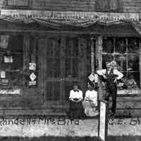          Birds_Drugstore_tu_best.jpg 1.1MB - Digital file on Jack Sheridan Drive 2021.72.02; Mary Randell and Mrs. Bird, C.E. Bird in front of their drug store, the former Ensign Drug Store - presentation image 9
   