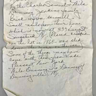 Note describing some items in Group A: Text reads "Items used in Singapore, MI by the Charles Samuel and Mila Dunning Jenkins family. Brick is from sawmill. Small nails from their home which is now at 333 Lucy Street, Saugatuck, MI. (Placed crooked on the lot in 1868 - was slid down[up] the river on the ice). Some of the things may have come with them from Lake Pleasant, New York. Mila Dunning is a Dunning of Dunningville, NY."
