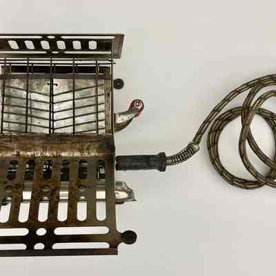 Side view with one door folded down to expose the heating element.: When powered on, the black wire heating elements would glow red.