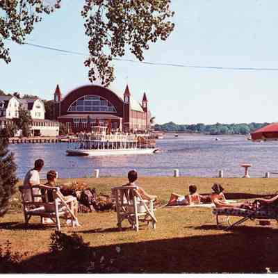 89-1-19D.jpg 872KB: People on lawn furniture gazing across Lake Kalamazoo toward the Island Queen and the Pavilion