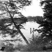          95 84 1 Kalamazoo scene.jpg 1.2MB; Box 31, envelope 95-84-1. For canoes on a smooth water are visible through the hemlock and oak branches on the shore.
   