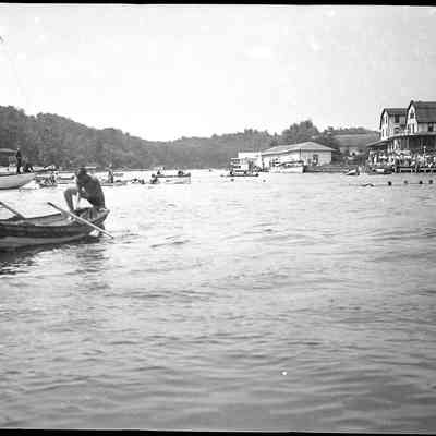 Pavilion_Water_carnival_B.jpg 635KB: Man climbing into dingy