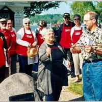          SDHS volunteer tour guides wearing their red aprons for a ribbon cutting cerimony; Ron Hirsch, George and Dawn Schumann, possibly Ken Gold, Harold Thieda, Kathleen Markland, Merle Malmquist, Kit Lane, unknown man with black hat, Dottie Lyon, and Jeff Spangler
   