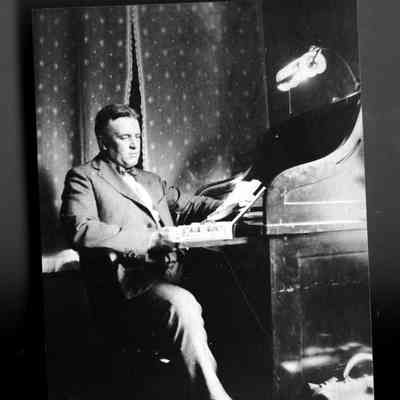 Deam38.jpg 303KB: Man seated at a roll top deck