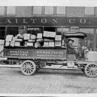          1908-10 Packard truck of B.A. Railton Co., loaded with goods; Packard Co. file photograph of a 1908-10 Packard right side view, parked on brick street in front of Railton Co. building, two men seated in front, side reads 