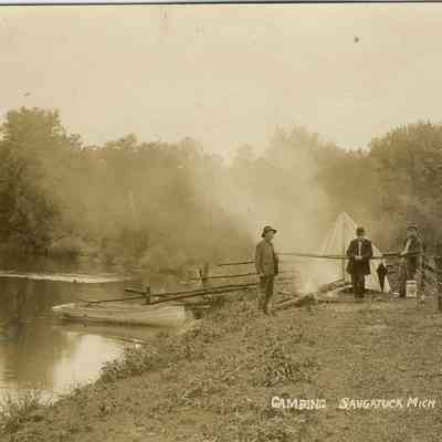 CWPC-0078Camping.JPG 241KB: Camping. Three men standing by a fire fence, a fabric tent, a rowboat, umbrella standing by.