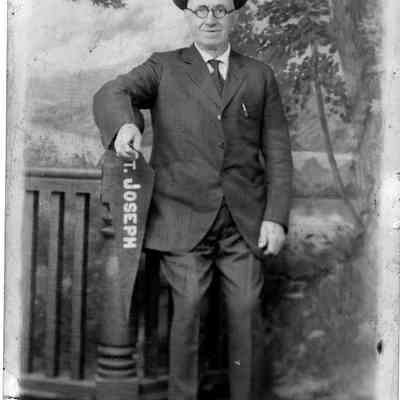 89-1-50 Tim Courtney.jpg 344KB: Tim Courtney standing with St. Joseph pennant. Studio photo, full length.
