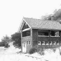          Photo from the book: two beachouses that once were on the shore and access road
   