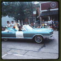          Page D 18. Miss Saugatuck Douglas 1968, Parade queens waving from back of convertible, on Butler Street in front of Bay Building.; Bay Building 110 Butler Street and Country Store Antiques at 120 Butler Street
   