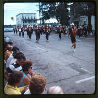          Page E People: 1. Saugatuck marching band parading up Butler street, The Butler in the background. August 1968. Likely Saugatuck Village Centennial.
   