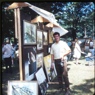 Page D 20. Man with SLR camera at air fair