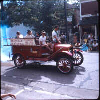          Page E 5. Antique firetruck with sign for Nashville Centennial, same parade as E1.
   