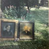 Snapshot of two portaits on a lawn