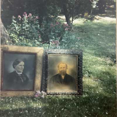 Snapshot of two portaits on a lawn
