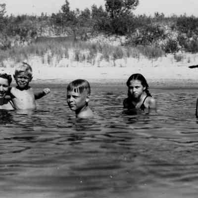 Family in water - loose.jpg 206KB: Woman and four children in shallow water on the beach