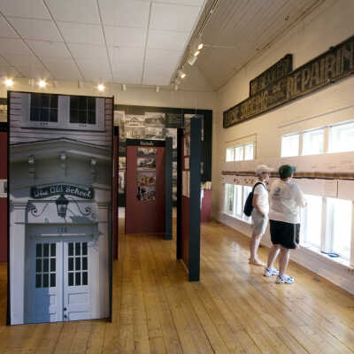 At right, over the windows: 16-foot aerial panorama photo of 6 miles of lake shore: At left, "hall of architecture"